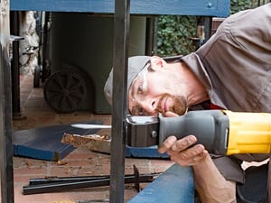 Image of a reciprocating saw cutting an iron post