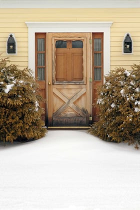 Front Walkway Covered in Snow Leading to Brown Door