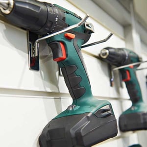 A drill hanging on a tool rack